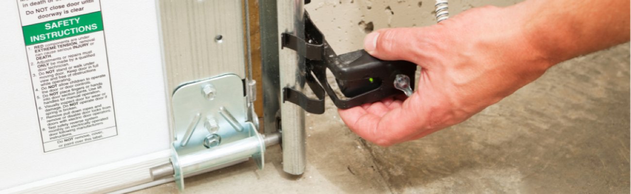 Person Completing Maintenance on a Garage Door