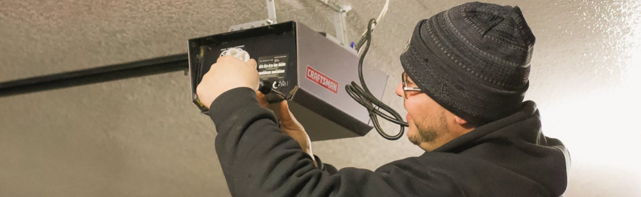 Technician Repairing a Garage Door Opener